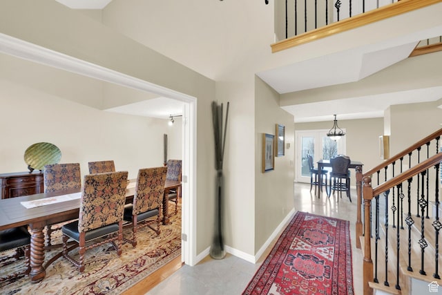 hallway with stairway and baseboards