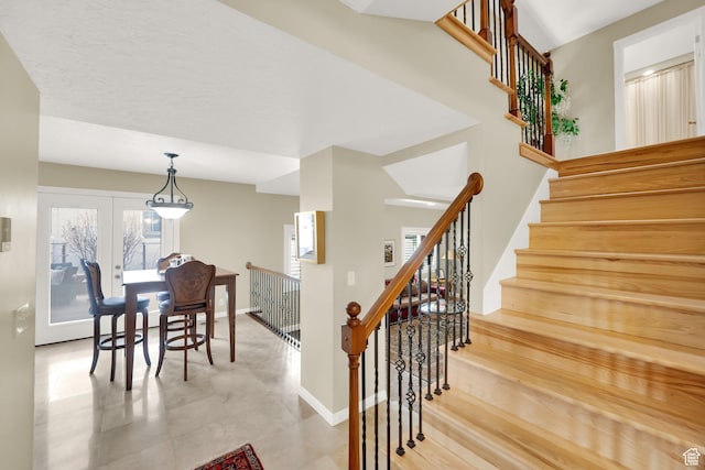 dining space with baseboards and stairway