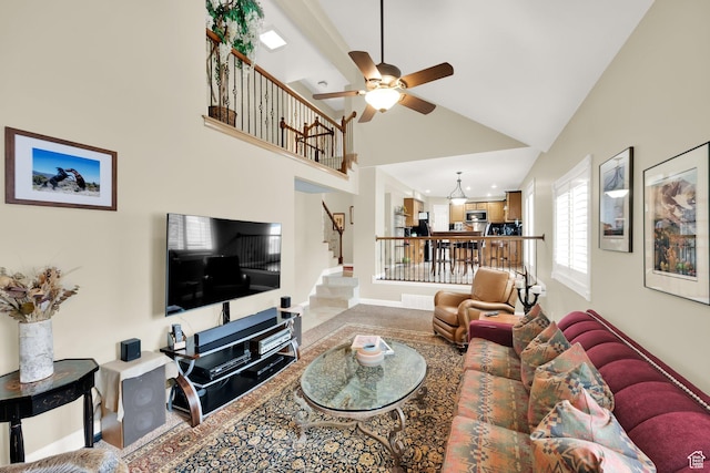 living room featuring high vaulted ceiling, stairs, visible vents, and ceiling fan