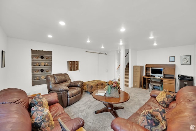 living area featuring light colored carpet, recessed lighting, and stairs