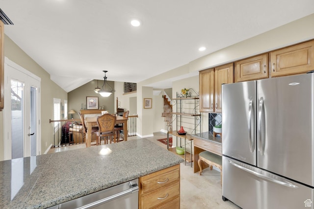 kitchen featuring recessed lighting, light stone countertops, vaulted ceiling, and appliances with stainless steel finishes
