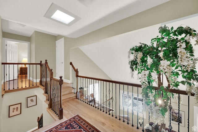 hallway featuring wood finished floors and baseboards