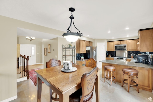 dining room featuring a chandelier, recessed lighting, baseboards, and stairs