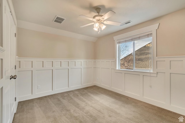 1135 Grandview Dr, Providence, UT 84332 - unfurnished room featuring a decorative wall, wainscoting, ceiling fan, and light colored carpet