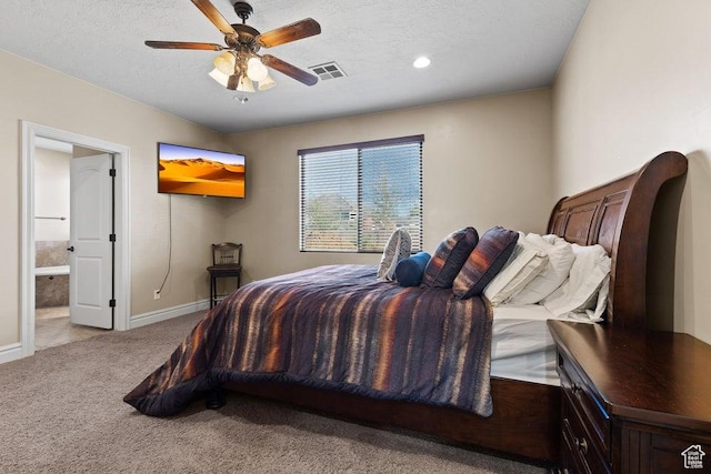 carpeted bedroom featuring visible vents, baseboards, connected bathroom, and a textured ceiling