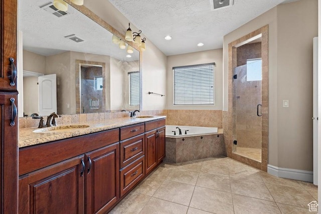 bathroom with a shower stall, a garden tub, and a sink