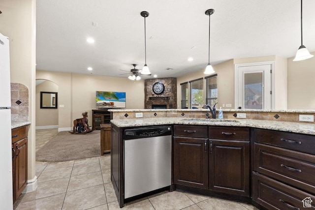 kitchen with a fireplace, a ceiling fan, dishwasher, a sink, and open floor plan