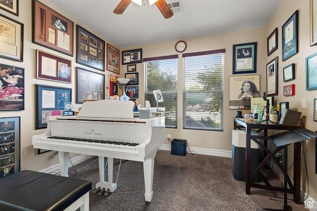 carpeted home office with wine cooler, visible vents, ceiling fan, and baseboards