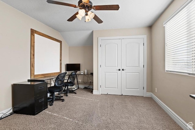 office area with ceiling fan, vaulted ceiling, carpet, and baseboards
