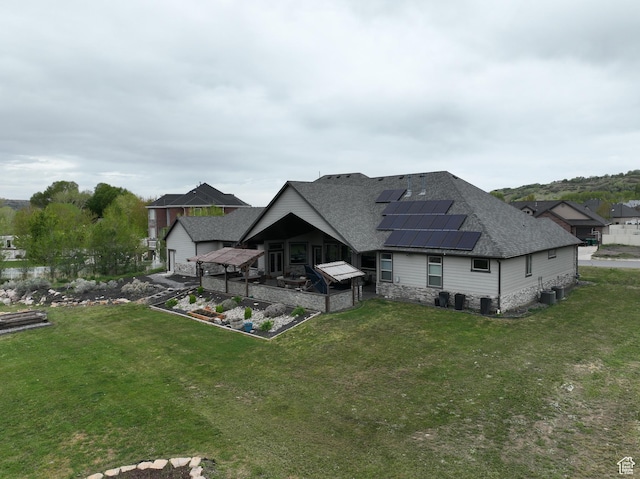 1737 E 6850 S, Uintah, UT 84405 - back of property with solar panels, a vegetable garden, a yard, and roof with shingles