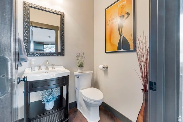 1737 E 6850 S, Uintah, UT 84405 - half bath featuring wood finished floors, toilet, and baseboards