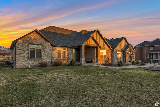 1737 E 6850 S, Uintah, UT 84405 - view of front of home featuring board and batten siding, stone siding, and a yard