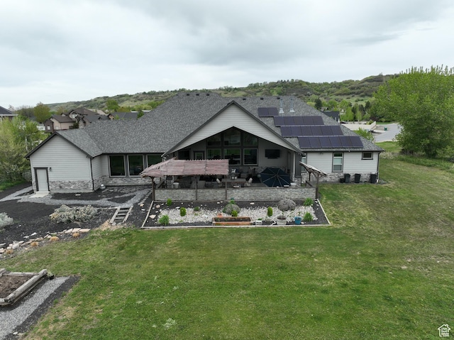 1737 E 6850 S, Uintah, UT 84405 - rear view of house featuring roof mounted solar panels, a yard, a vegetable garden, a patio, and a shingled roof