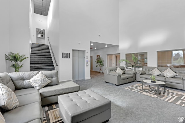 140 W 150 S Unit 22, Garden City, UT 84028 - carpeted living room featuring a high ceiling, stairs, and baseboards