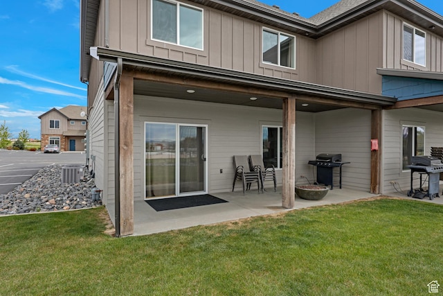 140 W 150 S Unit 22, Garden City, UT 84028 - rear view of house with board and batten siding, a patio, a lawn, and cooling unit