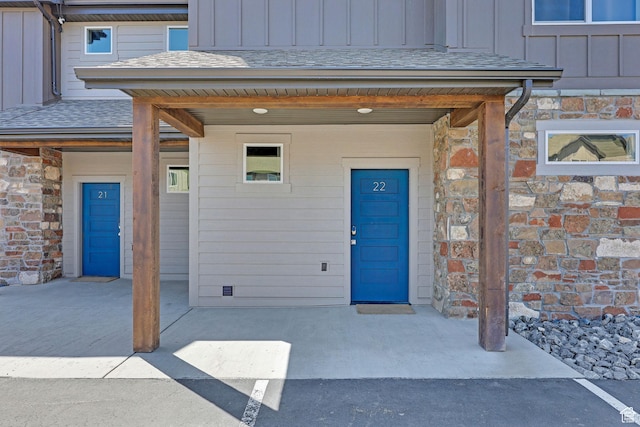 140 W 150 S Unit 22, Garden City, UT 84028 - property entrance with board and batten siding, stone siding, and a shingled roof