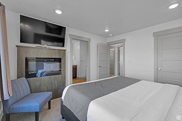 140 W 150 S Unit 22, Garden City, UT 84028 - bedroom with recessed lighting, a glass covered fireplace, and ensuite bath