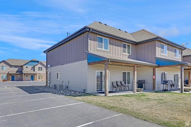 140 W 150 S Unit 22, Garden City, UT 84028 - rear view of house with board and batten siding, cooling unit, a patio area, uncovered parking, and a lawn