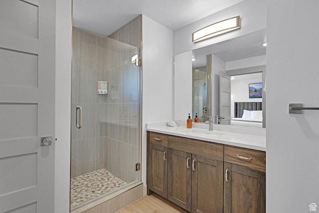 140 W 150 S Unit 22, Garden City, UT 84028 - full bathroom with a stall shower, ensuite bath, vanity, and wood finished floors