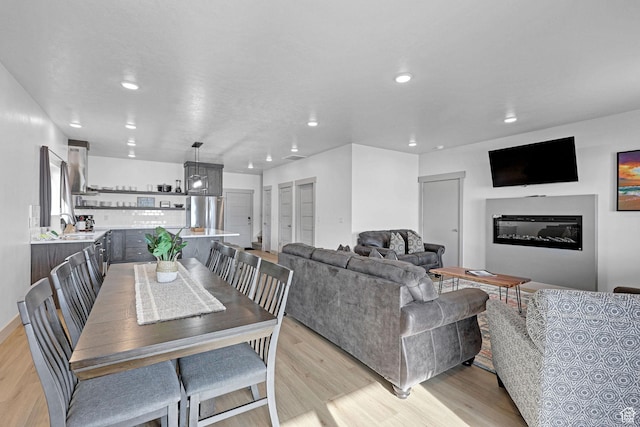 140 W 150 S Unit 22, Garden City, UT 84028 - dining room with recessed lighting, light wood-style flooring, and a glass covered fireplace