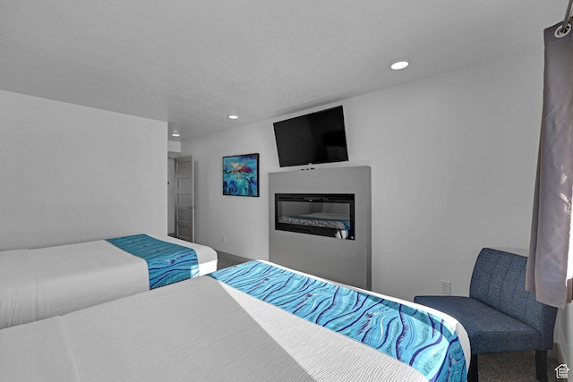 140 W 150 S Unit 22, Garden City, UT 84028 - carpeted bedroom featuring recessed lighting, a glass covered fireplace, and baseboards