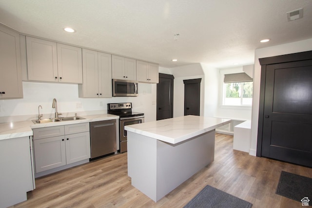 198 N 600 E, Hyrum, UT 84319 - kitchen with light wood-type flooring, recessed lighting, a kitchen island, appliances with stainless steel finishes, and a sink