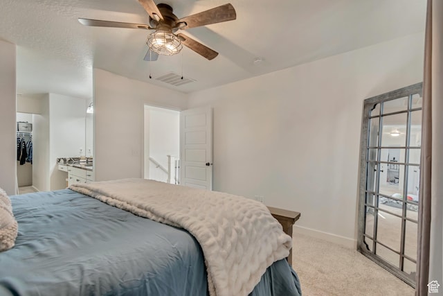 carpeted bedroom featuring visible vents, baseboards, and a ceiling fan