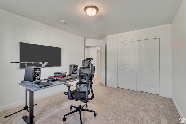 office space featuring light carpet and baseboards