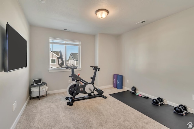 workout room featuring visible vents, baseboards, and carpet floors
