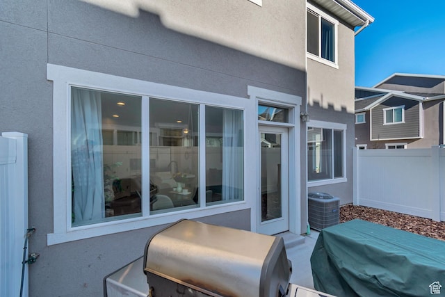 view of patio featuring grilling area, fence, and central air condition unit