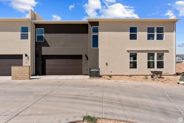 516 W Olive Ln, St George, UT 84790 - back of house with an attached garage, driveway, and stucco siding