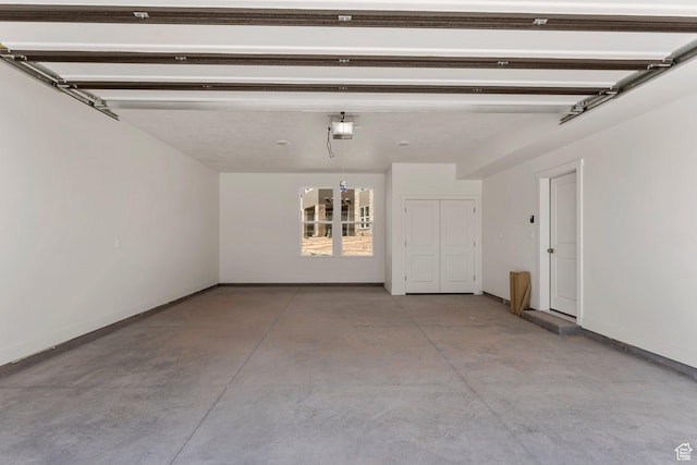 516 W Olive Ln, St George, UT 84790 - garage featuring a garage door opener and baseboards