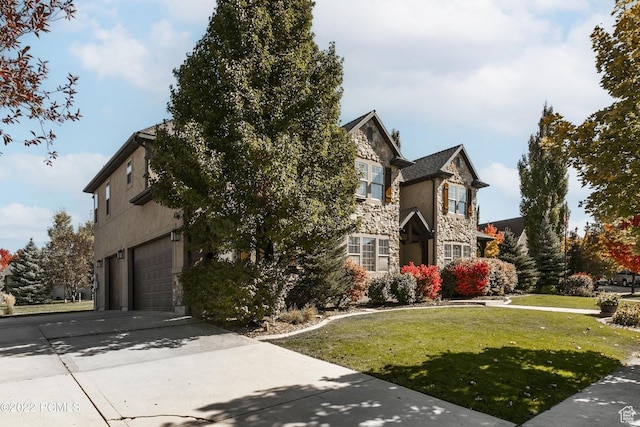 923 Ledgestone Ln, Heber City, UT 84032 - view of front facade featuring a front yard, driveway, stone siding, and an attached garage