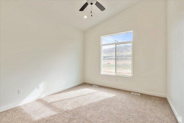 2329 E Woodbury Ln, Eagle Mountain, UT 84005 - empty room featuring visible vents, baseboards, ceiling fan, vaulted ceiling, and light colored carpet