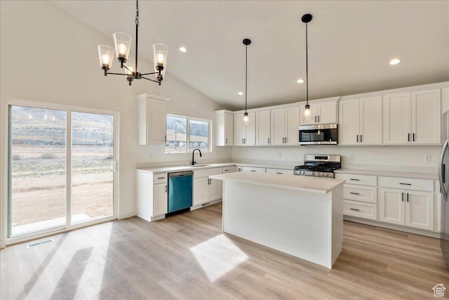 2329 E Woodbury Ln, Eagle Mountain, UT 84005 - kitchen with light wood-style floors, appliances with stainless steel finishes, light countertops, and visible vents