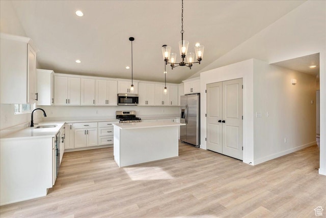 2329 E Woodbury Ln, Eagle Mountain, UT 84005 - kitchen featuring a center island, appliances with stainless steel finishes, light countertops, a sink, and a notable chandelier