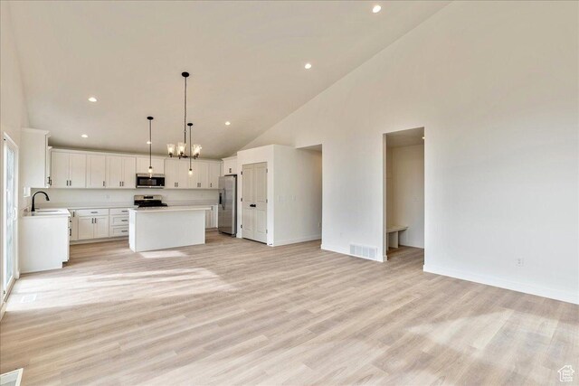2329 E Woodbury Ln, Eagle Mountain, UT 84005 - kitchen featuring visible vents, open floor plan, light countertops, stainless steel appliances, and a kitchen island