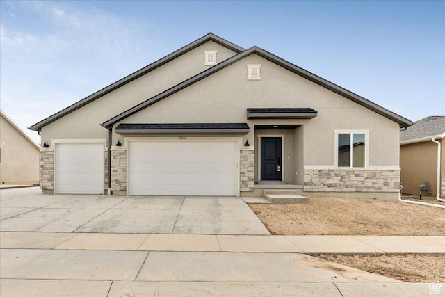 view of front facade with concrete driveway, stucco siding, stone siding, and a garage