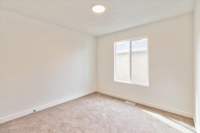 2329 E Woodbury Ln, Eagle Mountain, UT 84005 - unfurnished room with visible vents, baseboards, light colored carpet, and a textured ceiling