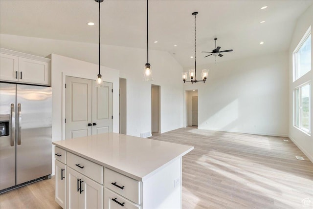2329 E Woodbury Ln, Eagle Mountain, UT 84005 - kitchen with a center island, white cabinetry, stainless steel refrigerator with ice dispenser, high vaulted ceiling, and light wood finished floors