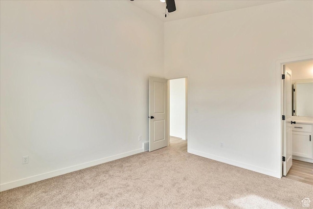 2329 E Woodbury Ln, Eagle Mountain, UT 84005 - empty room featuring a high ceiling, light colored carpet, baseboards, and ceiling fan