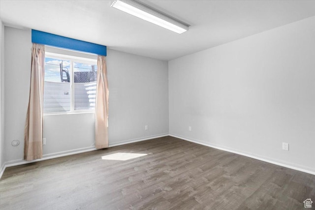 empty room with wood finished floors and baseboards