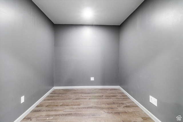 empty room with light wood-style flooring and baseboards