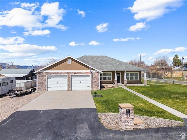 single story home featuring a front lawn, fence, a garage, and driveway