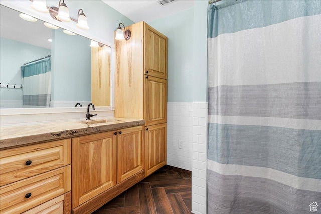 full bathroom featuring tile walls, vanity, and a shower with curtain