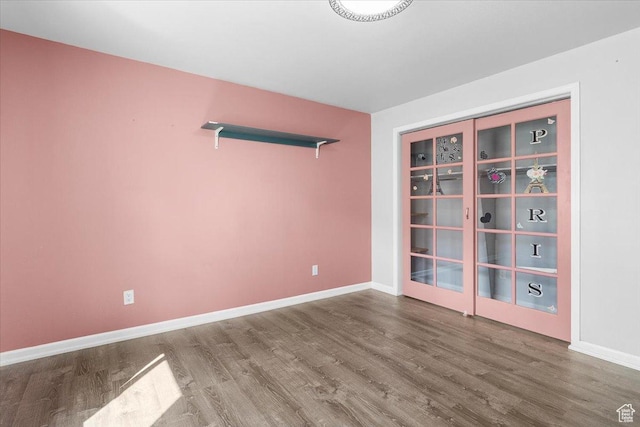 empty room with wood finished floors and baseboards