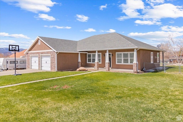 view of front of property featuring an attached garage, fence, stucco siding, a front lawn, and driveway