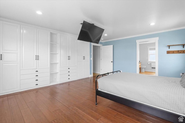 bedroom featuring recessed lighting, crown molding, connected bathroom, and wood finished floors