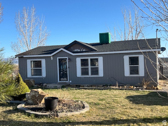 single story home with a front yard, central AC, and a chimney