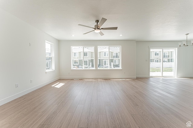 3683 W 950 N Unit 220, Lehi, UT 84043 - empty room with a chandelier, ceiling fan, light wood-style floors, and recessed lighting